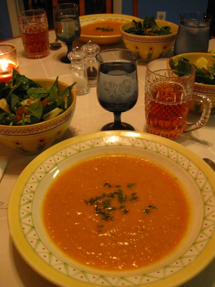 The soup, garnished with thyme, takes center stage. The apple theme runs through the whole meal, with apple and spinach salad on the side and a spiced, hard apple cider as the beverage for the evening.